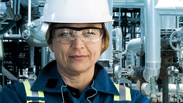 female engineer wearing hard hat and safety glasses